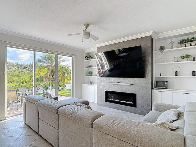 16435 SW 27th St, Miramar, FL 33027 - living area featuring light tile patterned floors, crown molding, built in shelves, a ceiling fan, and a textured ceiling