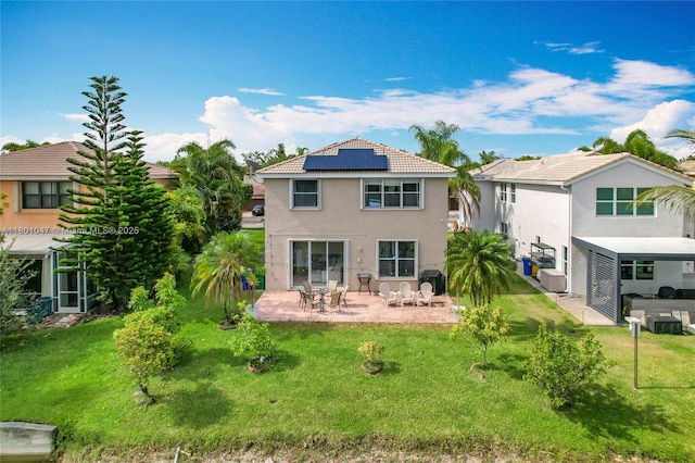 16435 SW 27th St, Miramar, FL 33027 - back of house featuring a patio area, roof mounted solar panels, stucco siding, a yard, and a tiled roof