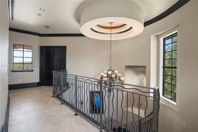 20508 SW 140th Ave, Miami, FL 33177 - hallway with an upstairs landing, a chandelier, ornamental molding, baseboards, and light tile patterned floors