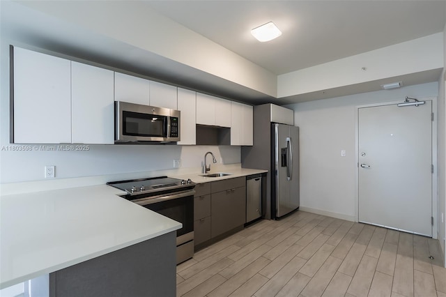 321 NE 26th St Unit 614, Miami, FL 33137 - kitchen featuring appliances with stainless steel finishes, light countertops, light wood finished floors, and white cabinets
