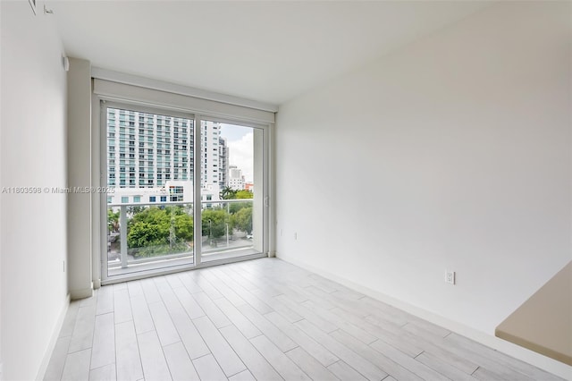 321 NE 26th St Unit 614, Miami, FL 33137 - unfurnished room featuring a view of city and light wood-style floors
