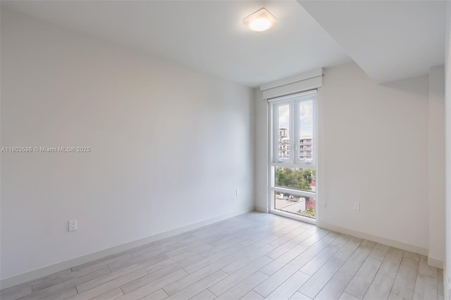 321 NE 26th St Unit 614, Miami, FL 33137 - empty room featuring light wood finished floors and baseboards