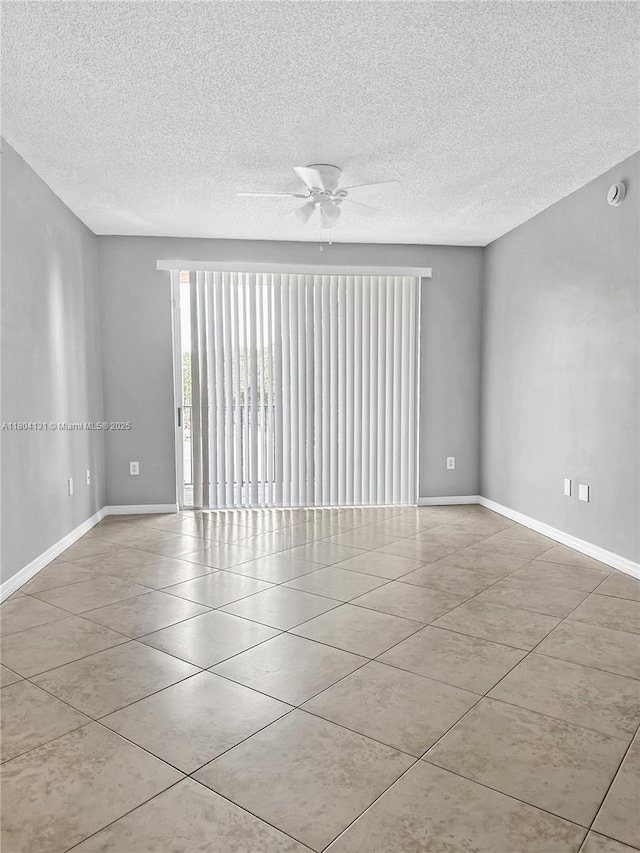 2240 E Preserve Way Unit 205, Miramar, FL 33025 - tiled empty room with ceiling fan, a textured ceiling, baseboards, and a smoke detector