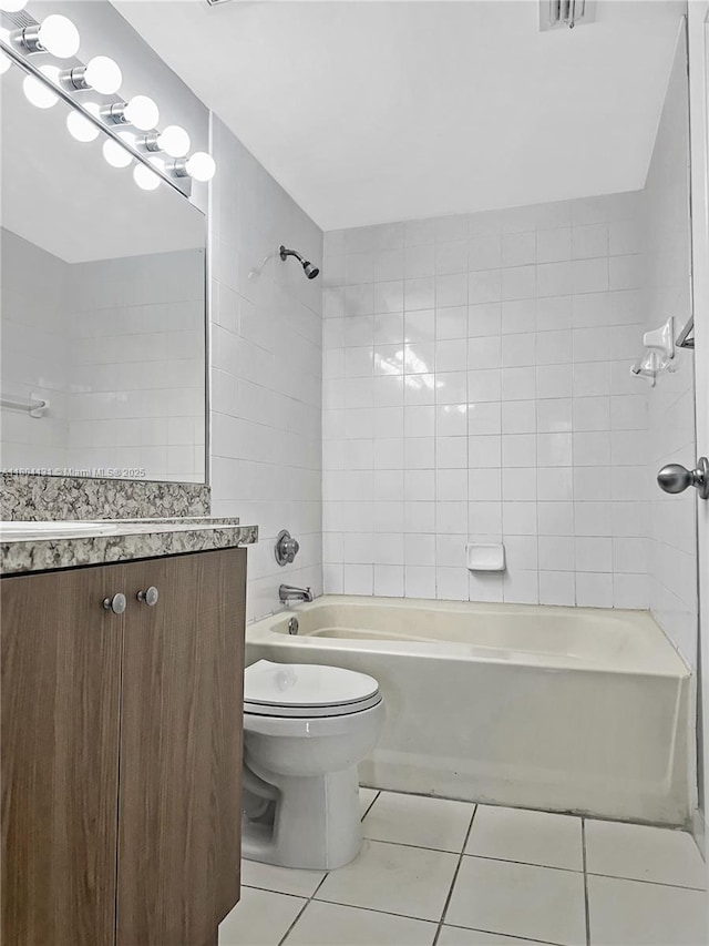 full bath featuring tile patterned flooring, toilet, shower / bathtub combination, and vanity