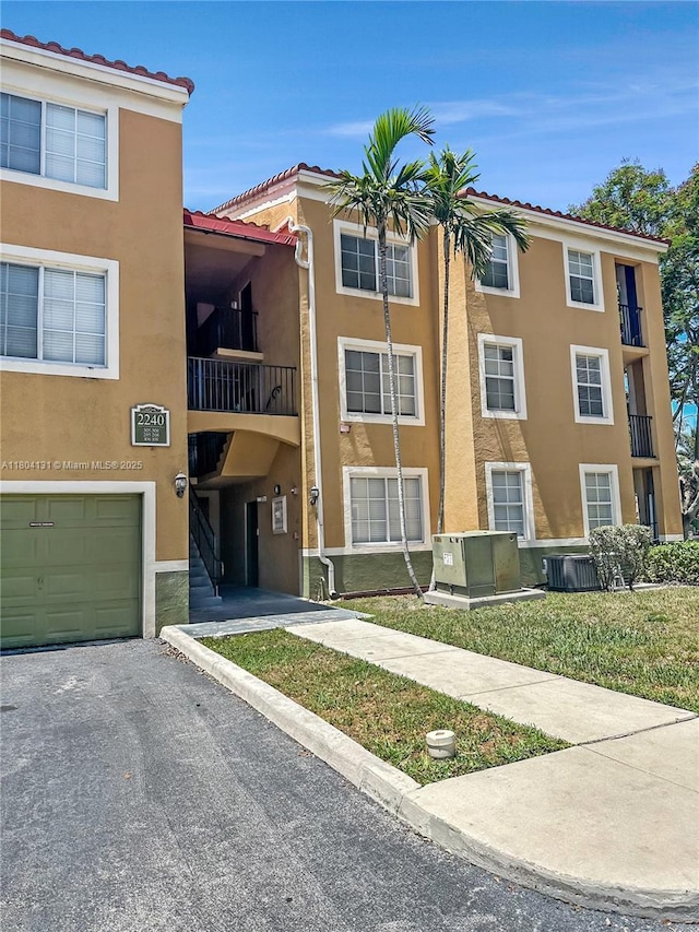 2240 E Preserve Way Unit 205, Miramar, FL 33025 - view of property featuring a garage, central AC, and asphalt driveway