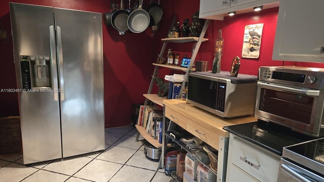 1993 E Discovery Cir E, Deerfield Beach, FL 33442 - kitchen featuring appliances with stainless steel finishes, light tile patterned floors, white cabinetry, and open shelves