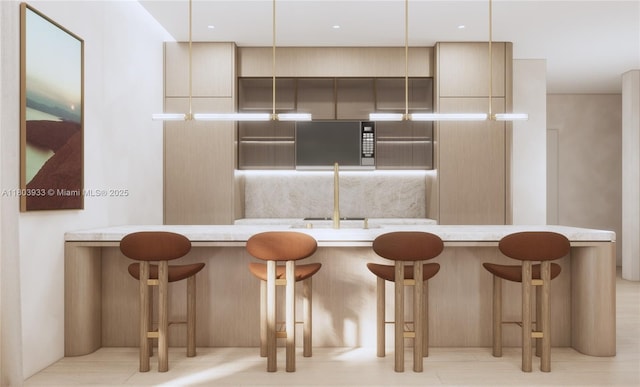 1265 SW 22nd St Unit Th-2, Miami, FL 33145 - kitchen featuring modern cabinets, a breakfast bar, and light countertops