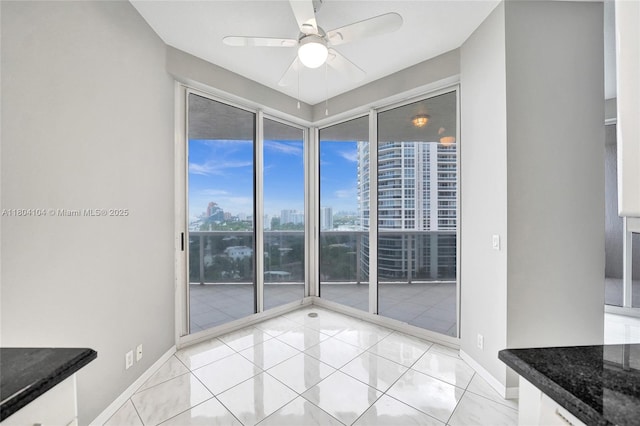 3200 N Ocean Blvd Unit 1206, Fort Lauderdale, FL 33308 - spare room featuring a view of city, ceiling fan, baseboards, and light tile patterned flooring