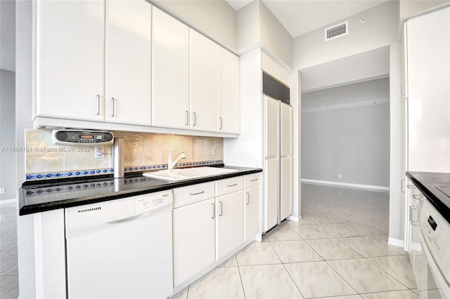 3200 N Ocean Blvd Unit 1206, Fort Lauderdale, FL 33308 - kitchen featuring dishwasher, a sink, backsplash, dark countertops, and white cabinets