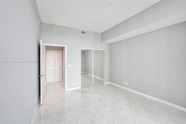 3200 N Ocean Blvd Unit 1206, Fort Lauderdale, FL 33308 - unfurnished bedroom with baseboards, a closet, and light tile patterned floors