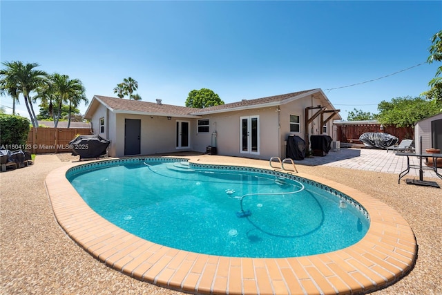 22226 SW 65th Ter, Boca Raton, FL 33428 - view of swimming pool with a patio, a fenced backyard, and french doors