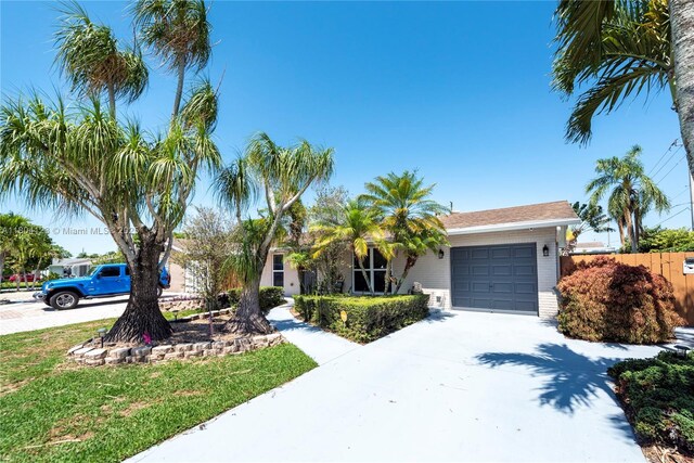 22226 SW 65th Ter, Boca Raton, FL 33428 - view of front of house featuring a garage, driveway, brick siding, and fence