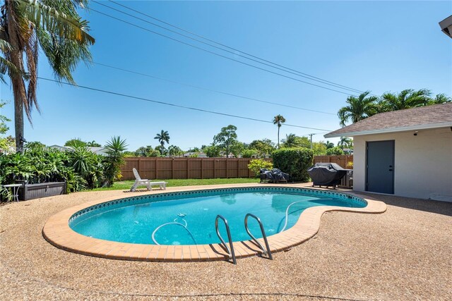 22226 SW 65th Ter, Boca Raton, FL 33428 - view of swimming pool with a fenced backyard, a grill, and a patio