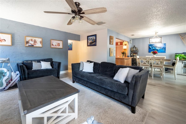22226 SW 65th Ter, Boca Raton, FL 33428 - living area with a textured ceiling, wood finished floors, and ceiling fan