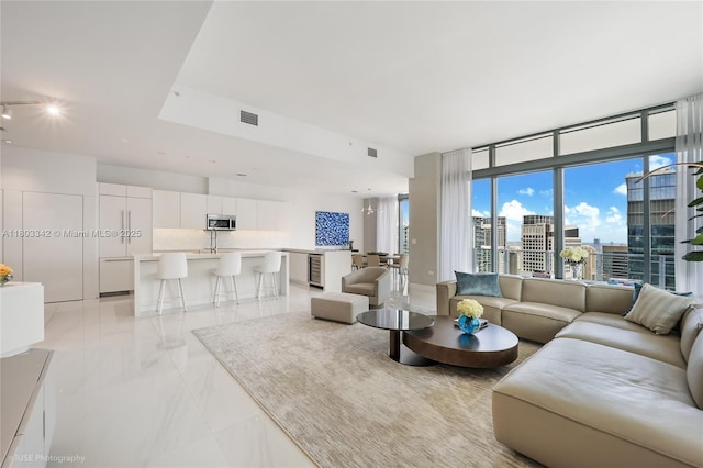 88 SW 7th St Unit 4101, Miami, FL 33130 - living room featuring light marble finish floors, a city view, and track lighting