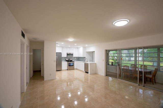 17252 SW 112th Pl Unit 21243, Miami, FL 33157 - kitchen with stainless steel appliances, decorative backsplash, light countertops, white cabinets, and a sink