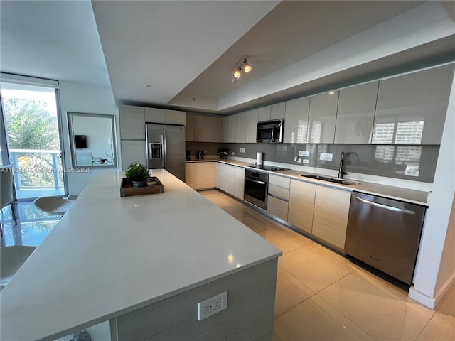 2600 E Hallandale Beach Blvd Unit T401, Hallandale Beach, FL 33009 - kitchen featuring appliances with stainless steel finishes, a sink, modern cabinets, light tile patterned floors, and light countertops