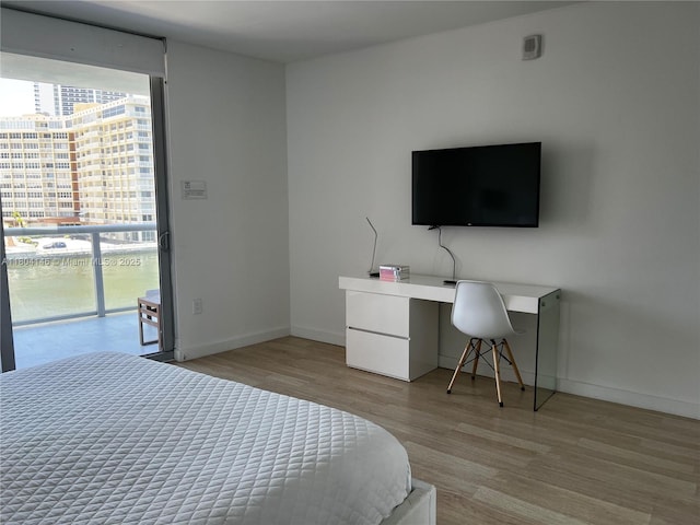 2600 E Hallandale Beach Blvd Unit T401, Hallandale Beach, FL 33009 - bedroom featuring light wood-style flooring, an office area, and baseboards