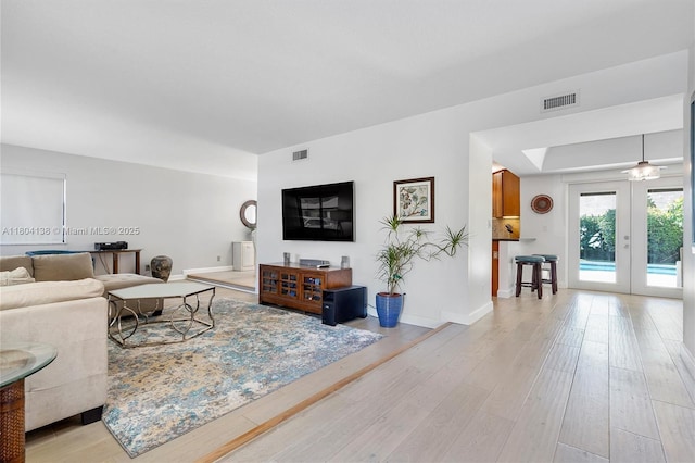 5630 W Waterford Dr, Davie, FL 33331 - living area with light wood-type flooring, baseboards, and french doors