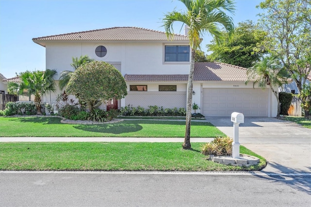 5630 W Waterford Dr, Davie, FL 33331 - view of front of home with a garage, concrete driveway, a tiled roof, a front yard, and stucco siding