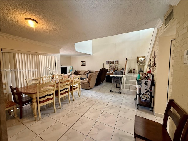 dining area featuring a textured ceiling and ornamental molding