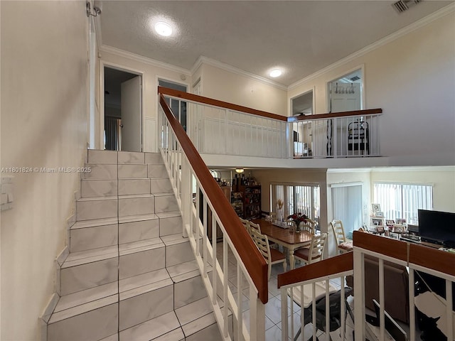 staircase featuring crown molding