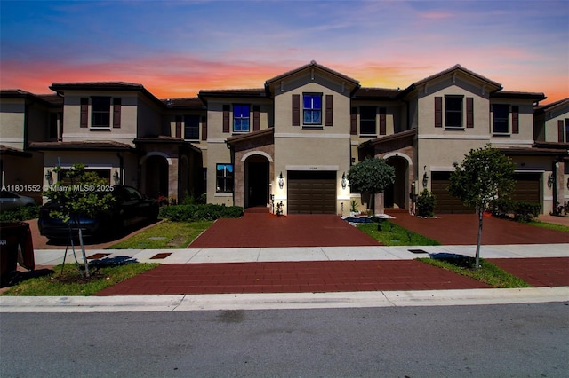 11094 W 33rd Way, Hialeah, FL 33018 - townhome / multi-family property featuring an attached garage, decorative driveway, and stucco siding