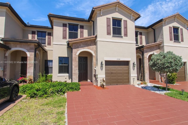 11094 W 33rd Way, Hialeah, FL 33018 - multi unit property featuring stucco siding, an attached garage, driveway, and stone siding