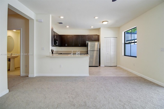 11094 W 33rd Way, Hialeah, FL 33018 - kitchen with stainless steel appliances, dark brown cabinetry, light colored carpet, a sink, and recessed lighting