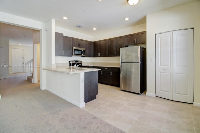 11094 W 33rd Way, Hialeah, FL 33018 - kitchen featuring stainless steel appliances, dark brown cabinets, a peninsula, light countertops, and baseboards