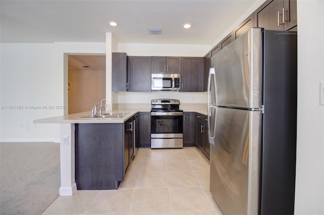 11094 W 33rd Way, Hialeah, FL 33018 - kitchen featuring stainless steel appliances, a sink, a peninsula, dark brown cabinets, and light countertops
