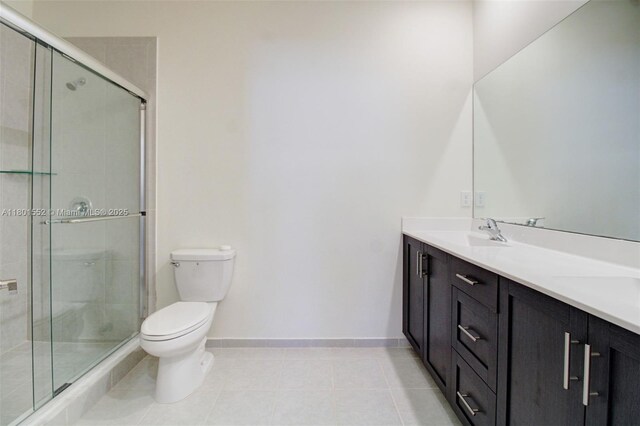 11094 W 33rd Way, Hialeah, FL 33018 - full bathroom with toilet, a shower stall, tile patterned flooring, double vanity, and baseboards
