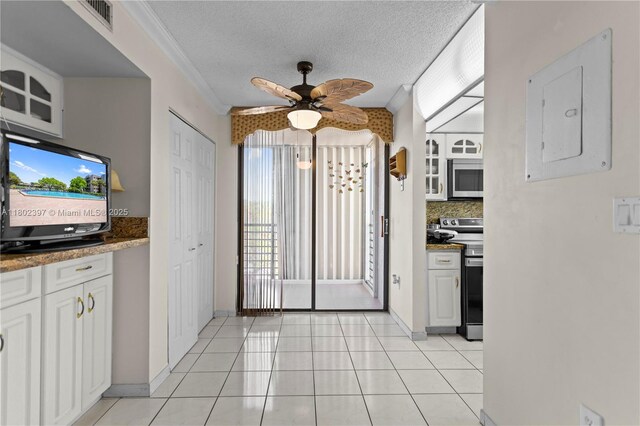900 Colony Point Cir Unit 523, Pembroke Pines, FL 33026 - kitchen with appliances with stainless steel finishes, decorative backsplash, a ceiling fan, light tile patterned floors, and white cabinets