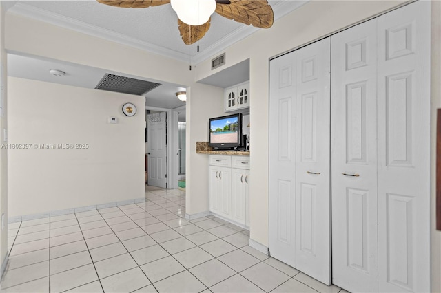 900 Colony Point Cir Unit 523, Pembroke Pines, FL 33026 - kitchen with crown molding, white cabinets, light tile patterned flooring, a ceiling fan, and baseboards