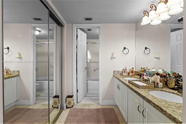 900 Colony Point Cir Unit 523, Pembroke Pines, FL 33026 - full bathroom with double vanity, bath / shower combo with glass door, baseboards, and tile patterned flooring