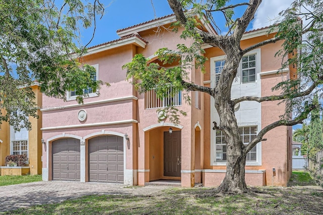 17668 SW 135th Ct, Miami, FL 33177 - view of front of house featuring a garage, stucco siding, driveway, and a tile roof