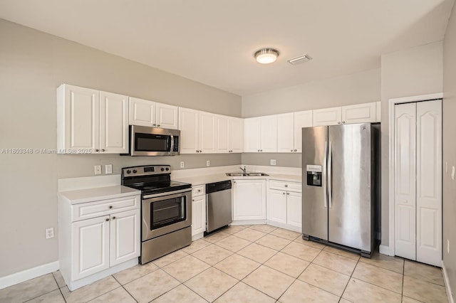 17668 SW 135th Ct, Miami, FL 33177 - kitchen with stainless steel appliances, a sink, light countertops, and light tile patterned floors