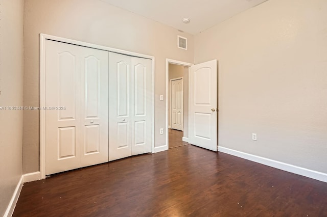17668 SW 135th Ct, Miami, FL 33177 - unfurnished bedroom with dark wood-type flooring, baseboards, and a closet