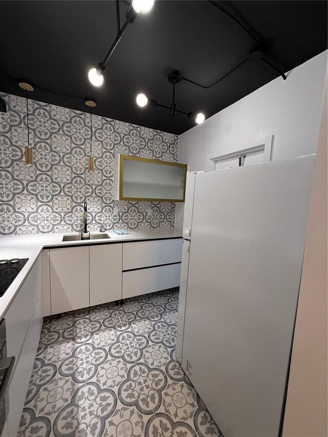 3209 S Ocean Dr Unit 2M, Hallandale Beach, FL 33009 - kitchen featuring freestanding refrigerator, white cabinetry, a sink, light countertops, and black stovetop