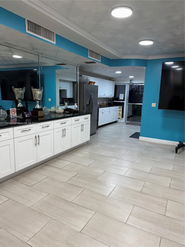 3209 S Ocean Dr Unit 2M, Hallandale Beach, FL 33009 - kitchen featuring black fridge, crown molding, dark countertops, white cabinets, and baseboards