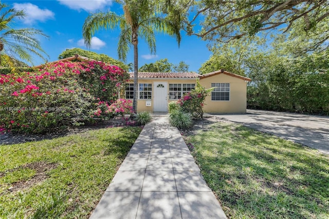 3610 SW 59th Ave, Miami, FL 33155 - mediterranean / spanish-style house featuring stucco siding, a tiled roof, and a front yard