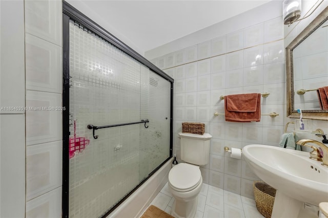 3610 SW 59th Ave, Miami, FL 33155 - full bath featuring tile walls, toilet, tile patterned flooring, a sink, and bath / shower combo with glass door