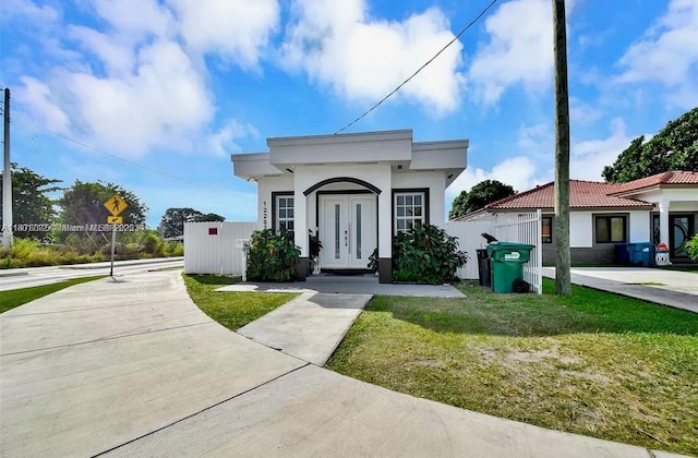 12202 SW 216th St, Miami, FL 33170 - view of front of property featuring stucco siding, french doors, and fence