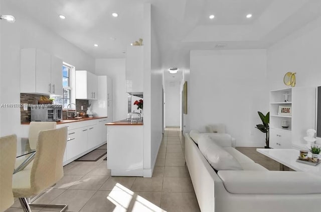 12202 SW 216th St, Miami, FL 33170 - kitchen with white cabinets, backsplash, light tile patterned floors, open floor plan, and a sink