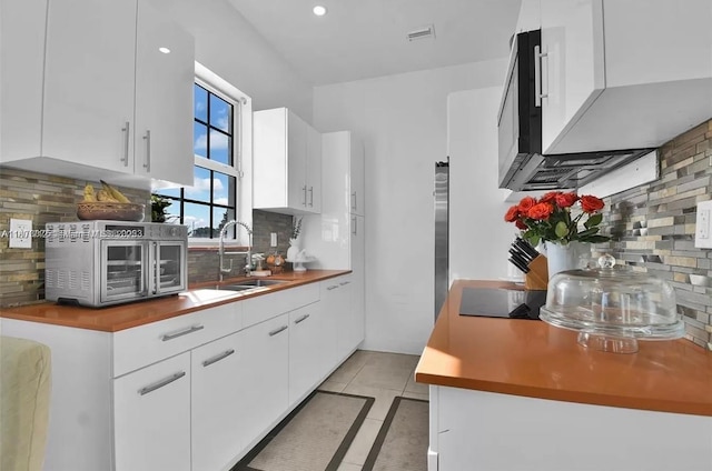 12202 SW 216th St, Miami, FL 33170 - kitchen with a sink, backsplash, white cabinets, light tile patterned floors, and recessed lighting