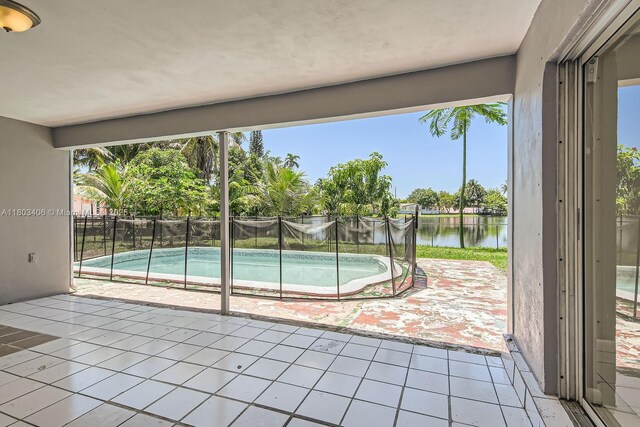 3226 NW 41st St, Lauderdale Lakes, FL 33309 - view of pool featuring a water view, a patio area, and fence