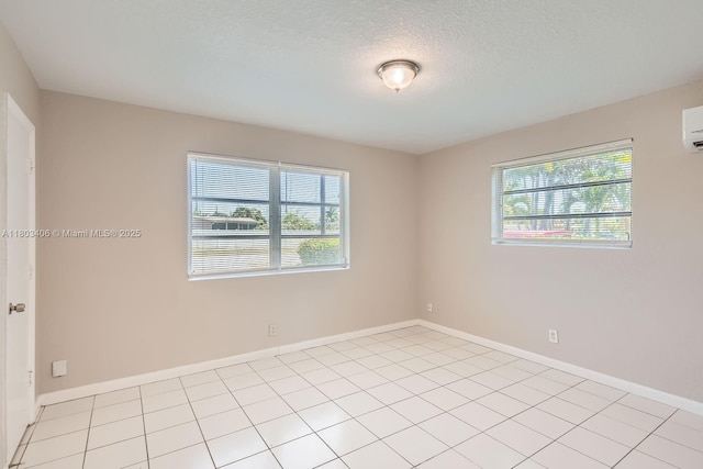 3226 NW 41st St, Lauderdale Lakes, FL 33309 - unfurnished room with plenty of natural light, a textured ceiling, baseboards, and a wall mounted AC