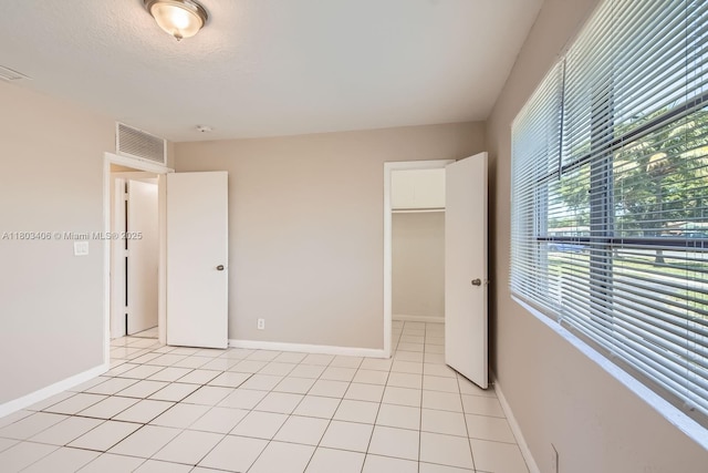 3226 NW 41st St, Lauderdale Lakes, FL 33309 - unfurnished bedroom with a spacious closet, baseboards, a closet, and light tile patterned flooring
