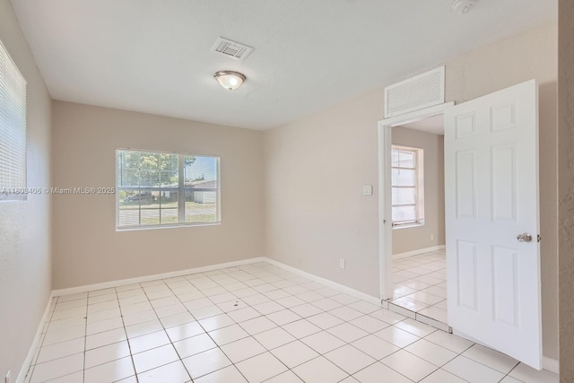 3226 NW 41st St, Lauderdale Lakes, FL 33309 - unfurnished room featuring healthy amount of natural light, light tile patterned floors, and baseboards