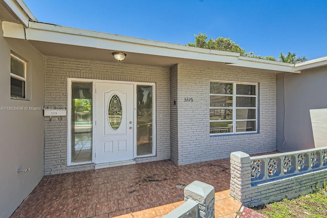 3226 NW 41st St, Lauderdale Lakes, FL 33309 - view of exterior entry featuring brick siding